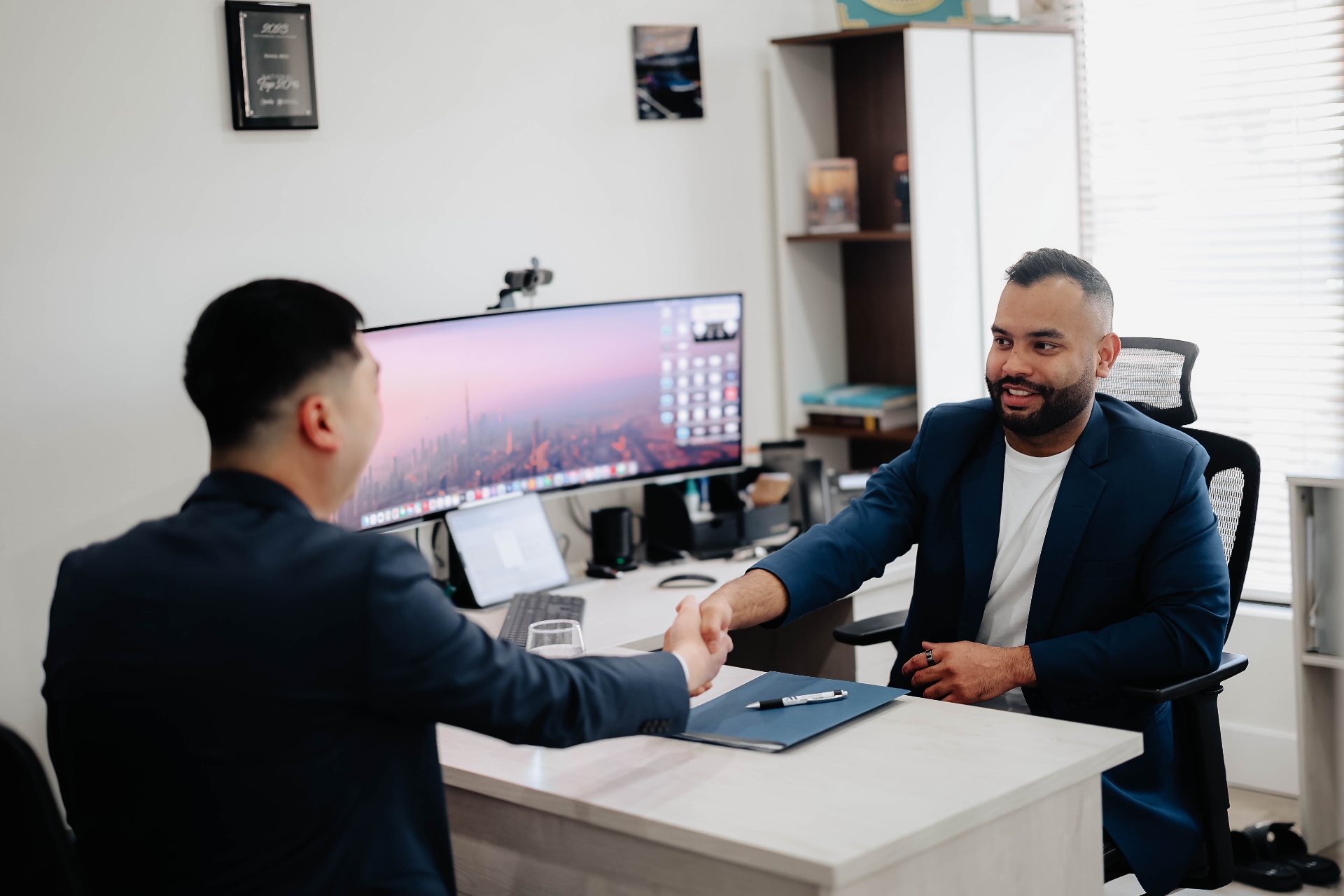 Rahul Bedi shaking hands with a client